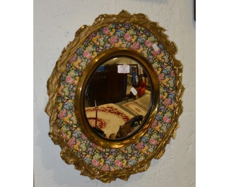 Ceramic and cast brass framed convex wall mirror, Chintz pattern, diameter 48cm.