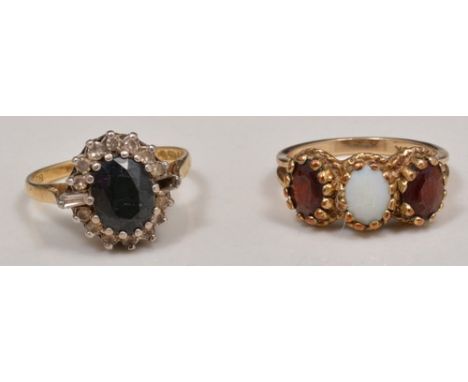 9ct hallmark gold garnet and opal three stone ring, and an 18ct diamond and sapphire dress ring (2).