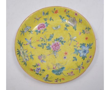 Chinese yellow ground circular dish, painted in famille rose enamel with flowers and insects, bearing six character seal mark