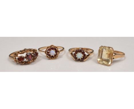 9ct hallmark gold garnet and opal dress ring, another garnet and opal dress ring, a garnet dress ring and a citrine set ring 