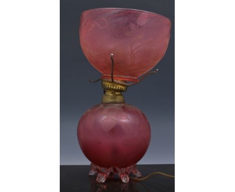 Ruby glass oil lamp, converted to electricity, acid etched spherical reservoir with a shade, 30cm.