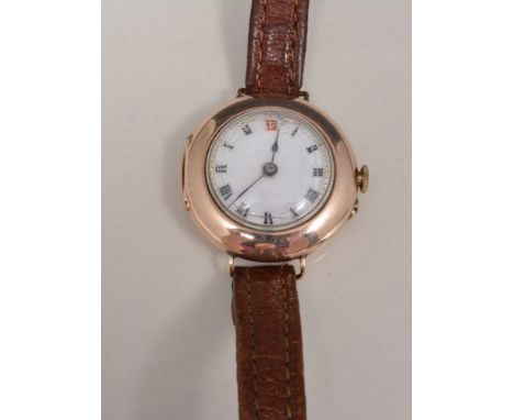 Ladies vintage 9ct gold wristwatch, circular case, white enamel dial, Swiss movement on a leather strap.