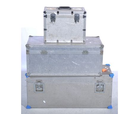 Three aluminium faced cases for camera equipment, one labelled "Angler News and Six", 91cm and smaller.
