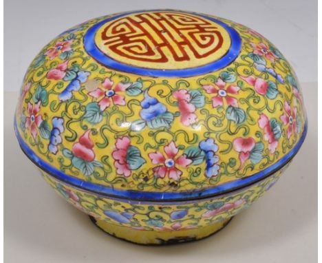 Cantonese enamel circular box, of cushion shape, yellow ground with floral decoration, diameter 9cm.