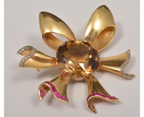 Yellow metal smokey quartz bow shape brooch, set with rose cut diamonds (one missing) and other stones.