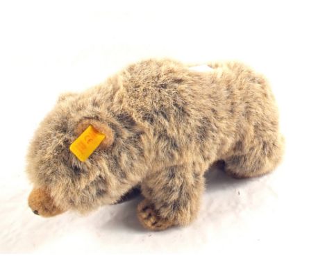 A Steiff bear with button and yellow label. THE TOTAL HAMMER PRICE FOR THIS LOT WILL BE DONATED TO EAST ANGLIAN AIR AMBULANCE