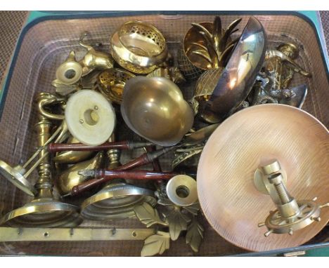A case containing a ships wheel nutcracker and other brass