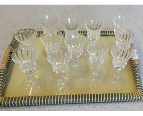 A set of ten heavy cut glass champagne flutes plus twelve cut stem wine glasses (two trays)