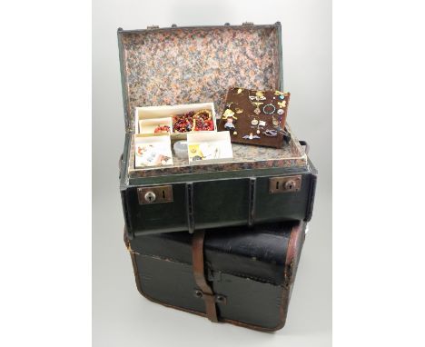 Two doll trunks, the first with black leatherette exterior and carry handles, with inner tray holding many useful beads and n