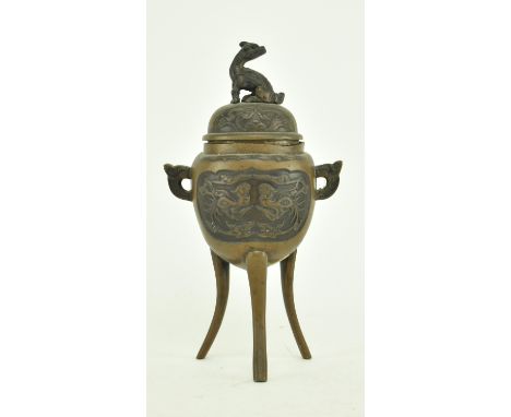 An early 20th century Japanese tripod censer. The censer decorated with two dragons motif with twin handles and a cover with 