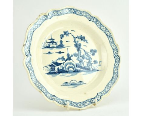 A late 18th century pearl ware blue and white plate. The plate decorated with a scene of landscape with fluted rim. A label w