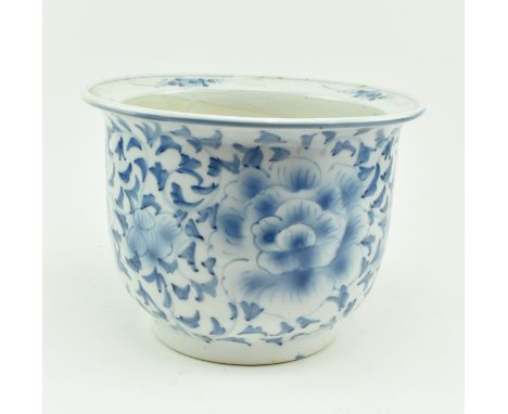 A vintage Chinese blue and white hand-painted ceramic planter. The everted rim planter decorated with peonies and leaves and 