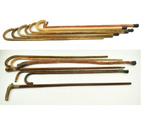 A collection of approximately thirteen early 20th century &amp; later wooden walking sticks &amp; canes. The lot to include e