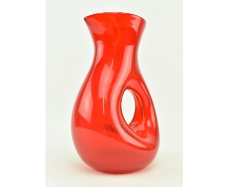 A vintage Scandinavian studio art glass decanter water jug in ruby red. The jug after similar examples by Pols Potten, with c