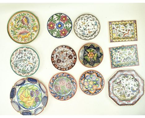 A collection of twelve vintage 20th century continental ceramic majolica plates, chargers and tiles. The lot to include tin-g