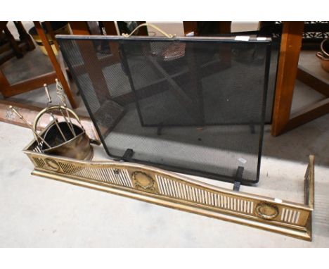 An early 20th century pierced brass fender with neoclassical garlands (internal measurement 130 cm wide x 22 cm) to/w brass a