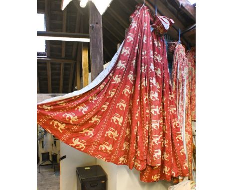 A pair of red curtains with ochre heraldic lion decoration, gathered tape header, lined and interlined and c/w pelmets etc on