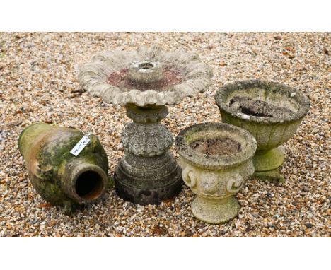 An assorted lot of garden features incl. a cast stone birdbath, a four handled amphora and two garden urns (4)