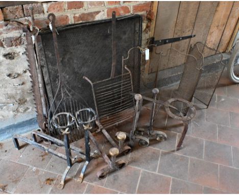 An assortment of French iron an steel fireplace items incl. three pairs of fire dogs, trivet, spark guards etc