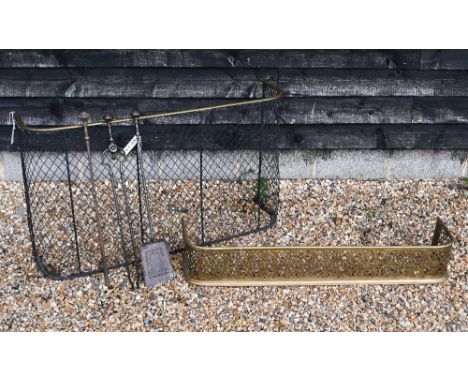 An antique nursery fire-guard with brass top-rail, 122 cm wide to/w a pierced fender and a set of steel fire-irons