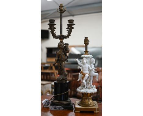 An Italian white-glazed and gilded ceramic lamp modelled with three dancing putti, on brass base, 48 cm high overall, to/w a 