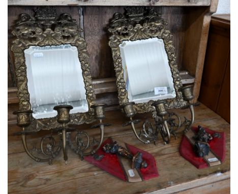 A pair of brass girandole mirrors with three candle-sconces, 46 cm high, to/w a pair of small wall shields mounted with bronz