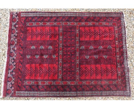 An old Afghan red ground carpet, 242 cm x 170 cm, pile ok but&nbsp;some&nbsp;evidence of old moth to ends