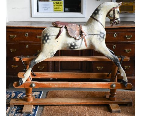 A 1920s wooden dapple-gray rocking horse, probably a Lines Brothers 'Sportiboy', on trestle base, 110 x 135 cm, for restorati