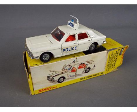Dinky Toys - A boxed Dinky #255 Ford Zodiac "Police" Car. The model with off-white body , red interior, blue roof light, and 