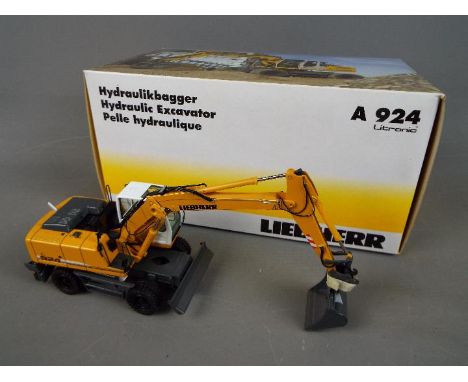 NZG - A boxed diecast 1:50 scale NZG #780 Liebherr A924 Litronic Hydraulic Excavator . The model in yellow and white appears 