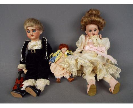 Armand Marseille - a bisque headed female doll with hand painted eyebrows eyelashes and lips with beauty mark under right eye