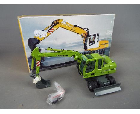 NZG - A boxed diecast 1:50 scale NZG #498 Liebherr Heim A314 Litronic Hydraulic Excavator. The model in green appears to be i