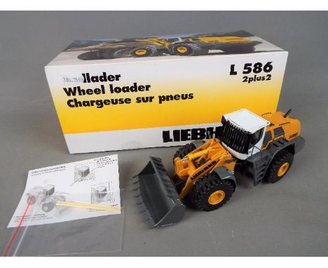 NZG - A boxed diecast 1:50 scale NZG #689/07 Liebherr L586 2plus2 Wheel Loader. The model in yellow and white appears to be i