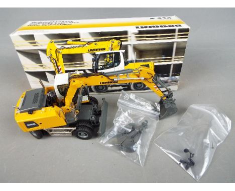 Conrad - A boxed diecast 1:50 scale Conrad #2946 Liebherr A920 Litronic Hydraulic Excavator. The model in yellow and grey app