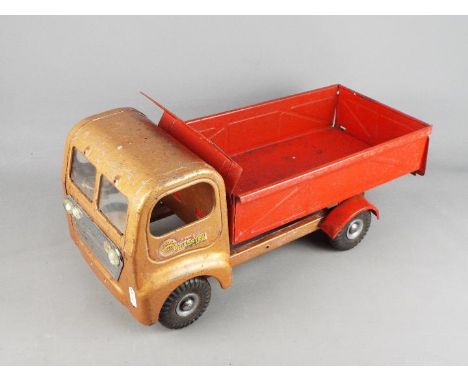 Triang - an unboxed Triang Regal Roadster Tipper Truck. The tinplate model in Red &amp; Gold has Triang decals to both doors,
