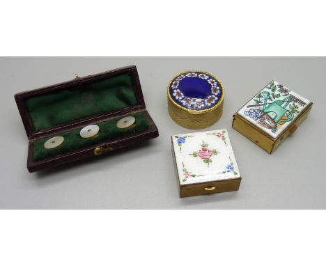 A guilloche enamel topped pill box, two other enamelled pill boxes and a cased set of mother of pearl buttons 