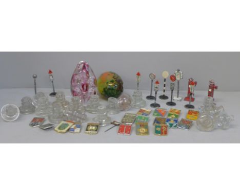 A collection of Soviet badges, glass drawer or cabinet knobs, M'dina and Langham glass paperweights and Dinky Toys street fur