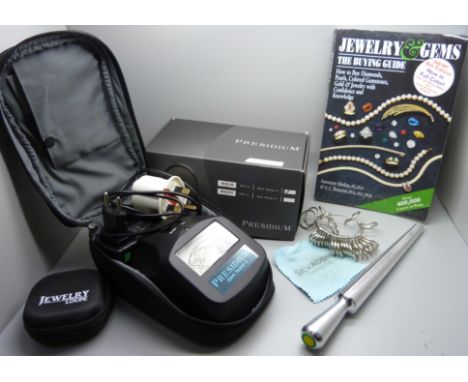 A Presidium gem tester, ring sizers, a jewellers loupe and a Jewellery and Gems Buying Guide book 