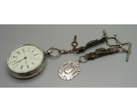 A silver cased centre seconds chronograph pocket watch, Isaac Falk, Manchester, Chester 1888, with an Albert, silver fob and 