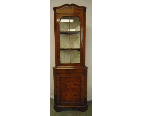 An Edwardian mahogany glazed corner cabinet on four bracket feet