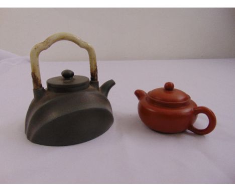 A Chinese terracotta teapot and another with carved jade handle