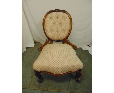 A Victorian upholstered button back boudoir chair on scroll legs