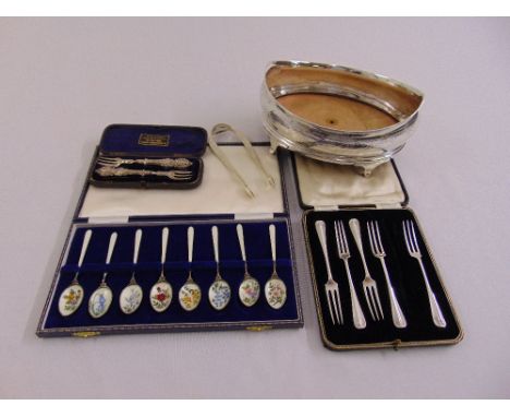 A quantity of silver to include a shaped oval bowl, a cased set of enamel spoons, cased flatware and a pair of sugar tongs