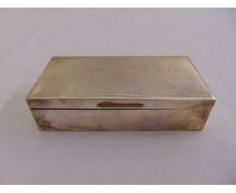 A rectangular silver engine turned cigarette box with hinged cover and cedar wood lining, Birmingham 1976