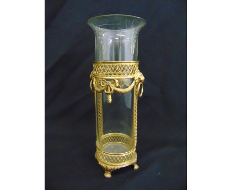 A gilded metal and cylindrical glass lantern on four claw feet