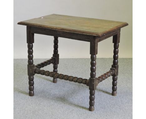 A 17th century oak side table, on bobbin turned legs, 76cm