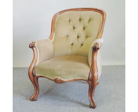 A Victorian carved mahogany green upholstered button back armchair 