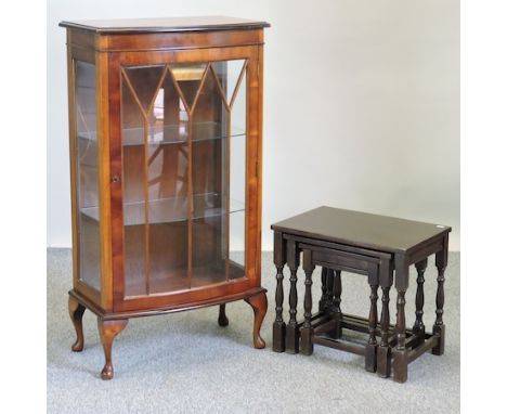 A yew wood bow front display cabinet, 62cm, together with a nest of three occasional tables