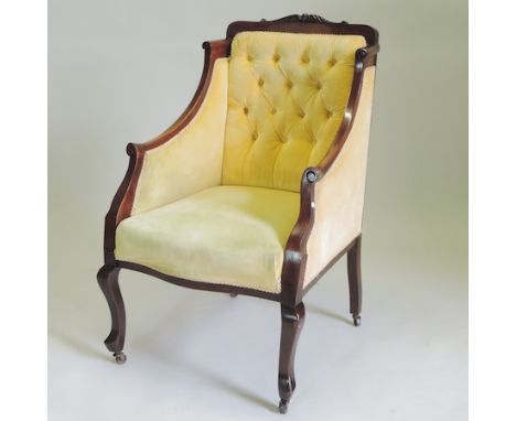 An Edwardian mahogany and gold upholstered button back armchair