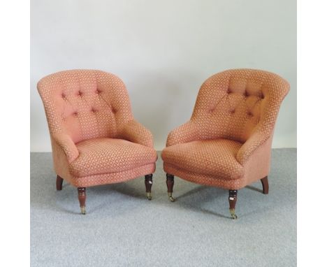A pair of modern red upholstered button back armchairs